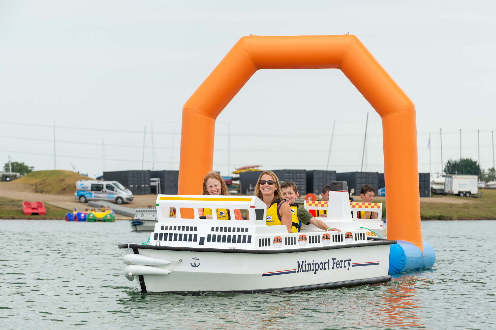 A mini electric ship that looks like a ferry with a mum, daughter and son on board