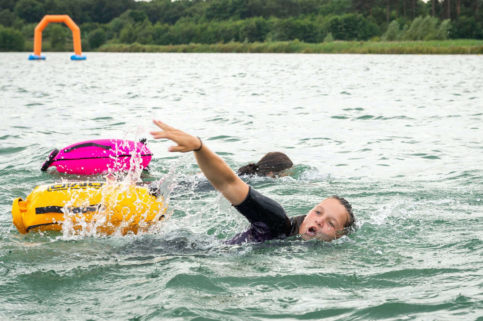 Woman mid front crawl, open water swimming in the lake