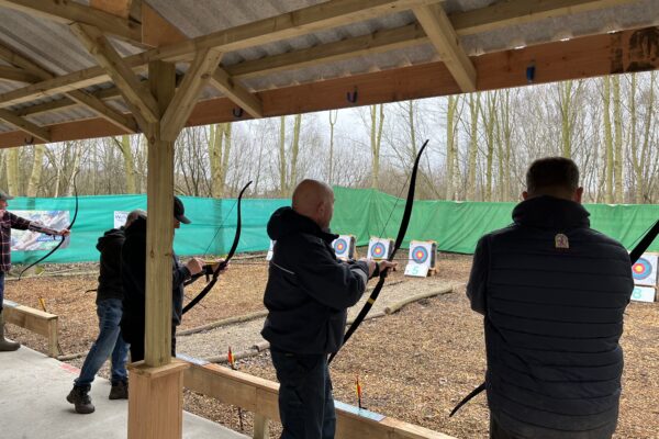 A group of people prepare to fire arrows at carefully positioned targets surrounded by woodland in North Yorkshire