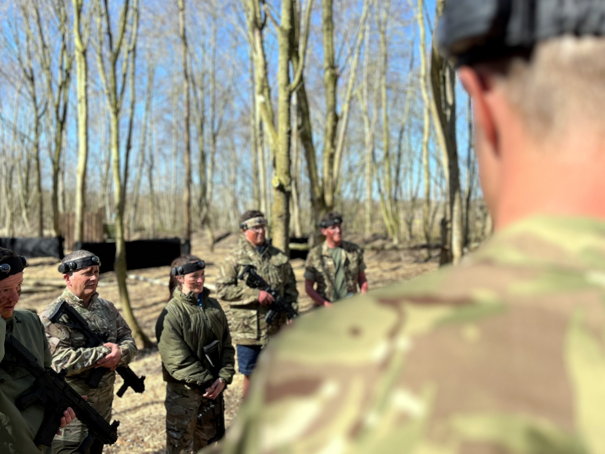 A group of people stand in a woodland preparing for a laser tag activity at North Yorkshire Water Park