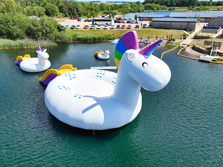 3 inflatable unicorns on a lake at wykeham NYWP