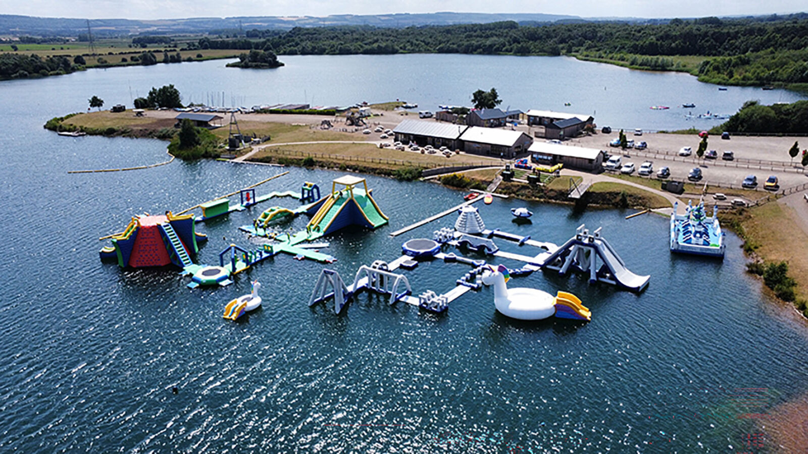 the ultimate aquapark 2026 on a lake with cafe and reception buildings in background at NYWP.