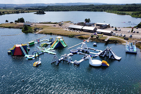 the ultimate aquapark 2026 on a lake with cafe and reception buildings in background at NYWP.